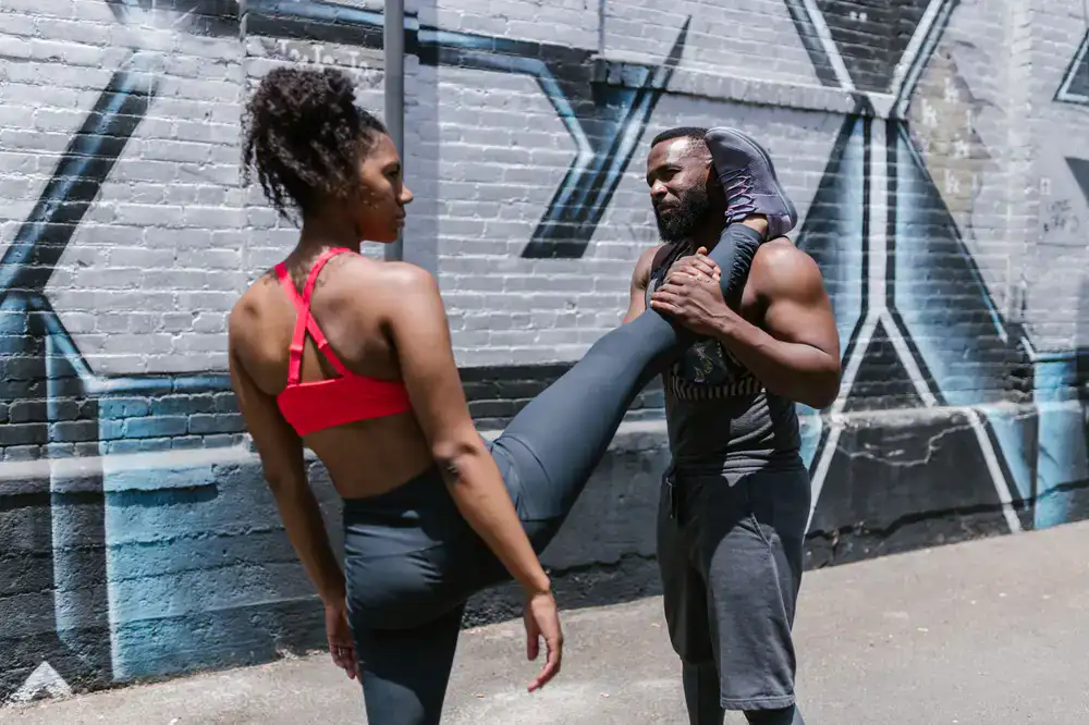 Personal trainer demonstrating a workout outdoors