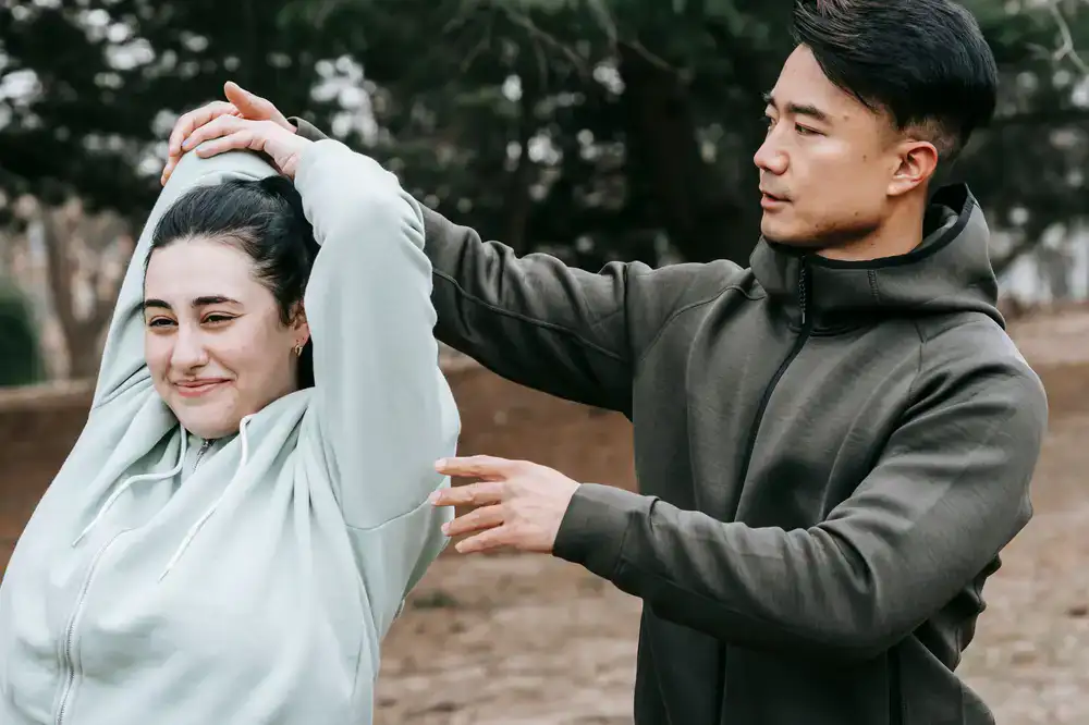 Personal trainer motivating a client during an outdoor workout